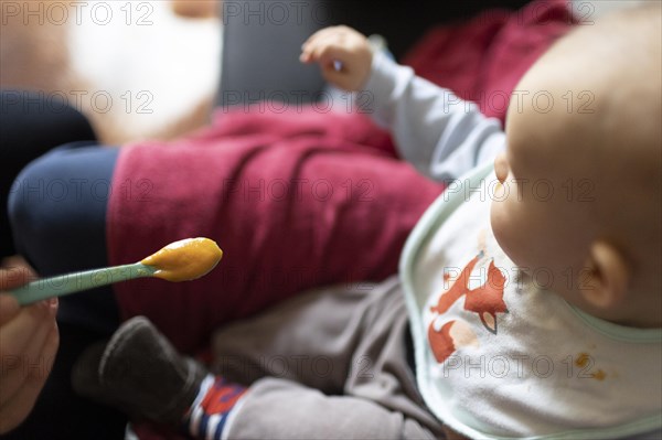 Child is fed with porridge