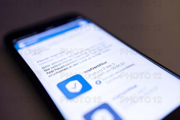 A digital vaccination certificate with a booster vaccination against the Corona virus is pictured on a smartphone in Berlin