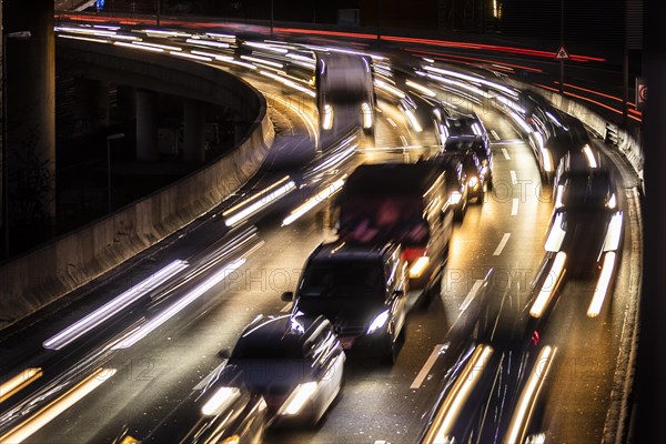 Congested traffic on the A100 looms at blue hour in Berlin