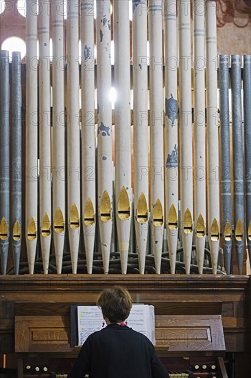 Organist playing Baroque pipe organ in the Jesuit Mission church of San Jose de Chiquitos