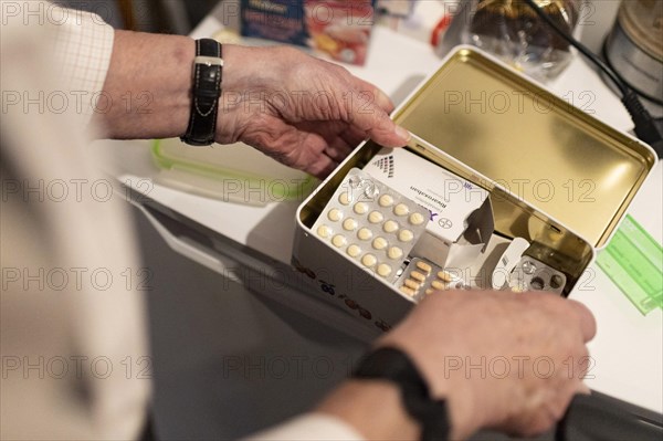 Dementia man with a box full of medication