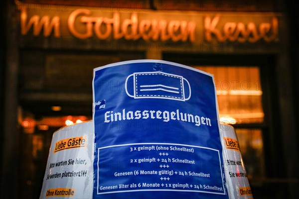 A sign outside a pub indicates the new catering access restrictions to combat the COVID-19 pandemic in Duesseldorf