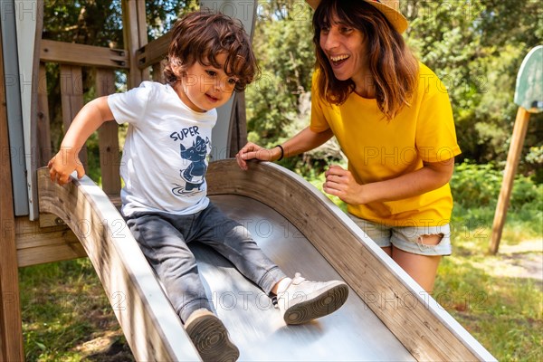 A mother having fun in a children's playground in La Llania park in El Hierro