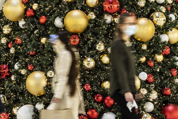 People stand out against Christmas decorations in a shopping centre on Schlossstrasse in Berlin