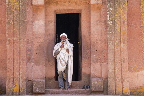 Priest leaving the Biete Gabriel-Rufael