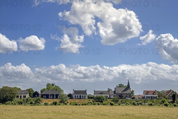 Village Gellicum showing Dutch Reformed Church and traditional houses on dike along the Linge river