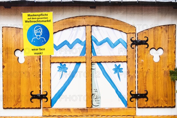 A sign indicating that masks are compulsory stands out at the Christmas market on Alexanderplatz in Berlin