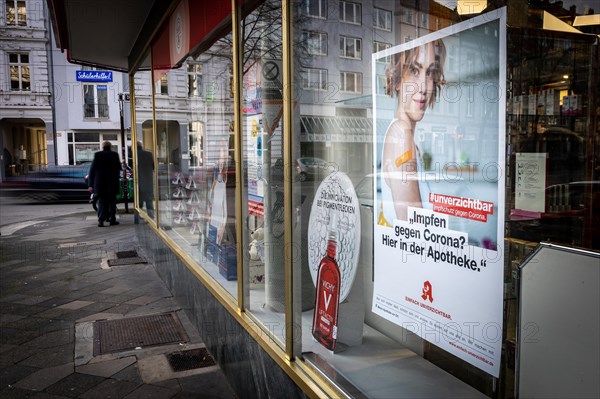 A poster in a pharmacy advertising the possibility to be vaccinated at pharmacies in Duesseldorf