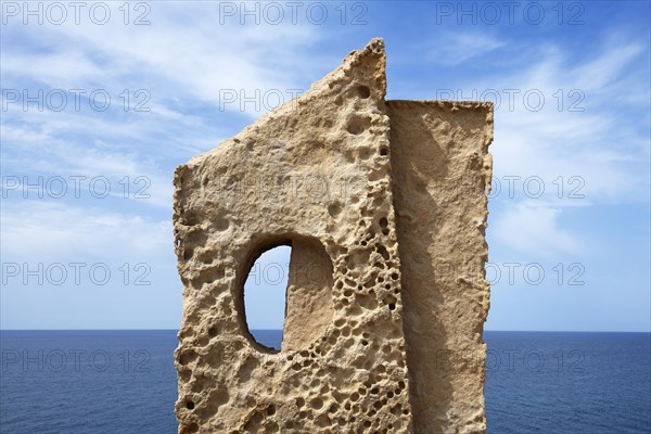 Stone sculpture in front of the coast