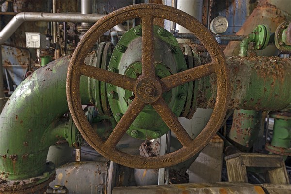 Rusty shut-off wheel on a water pipe of a former paper factory