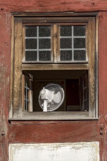 Window with fan to cool the room in hot weather