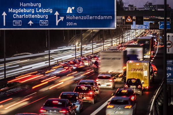 Congested traffic on the A100 looms at blue hour in Berlin