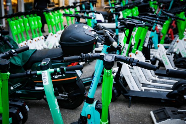 E-scooters of various providers standing on a designated parking space for sharing providers in Duesseldorf