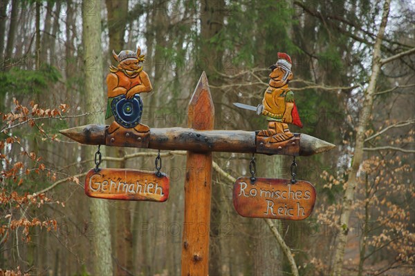 Historical Limes Boundary with signpost by wooden figures