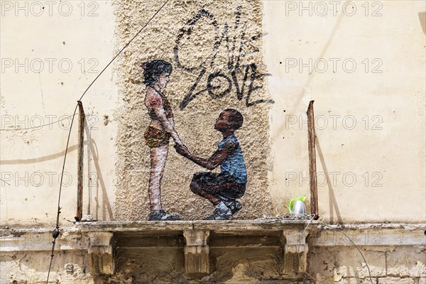 Mural One Love on weathered facade