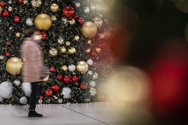 People stand out against Christmas decorations in a shopping centre on Schlossstrasse in Berlin