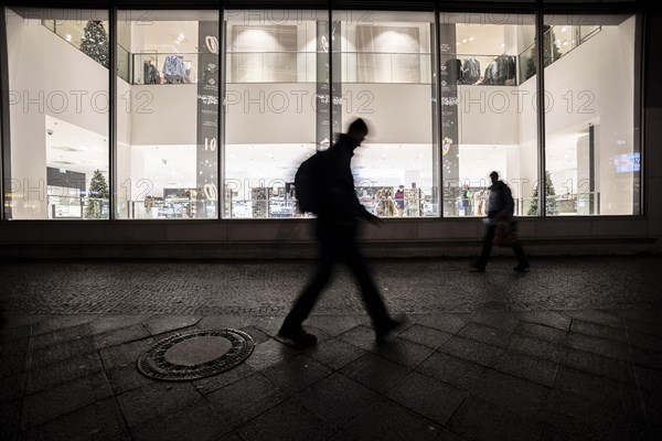 People stand out against Christmas decorations in a shopping centre on Schlossstrasse in Berlin