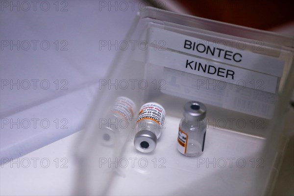 Used ampoules of the BioNTech Pfizer vaccine for children lie in a compartment in a COVID-19 vaccination and testing centre at the Olsen car dealership in Iserlohn
