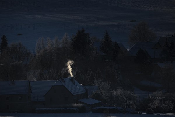 Smoke is visible from the chimneys on an icy morning in Koenigshain