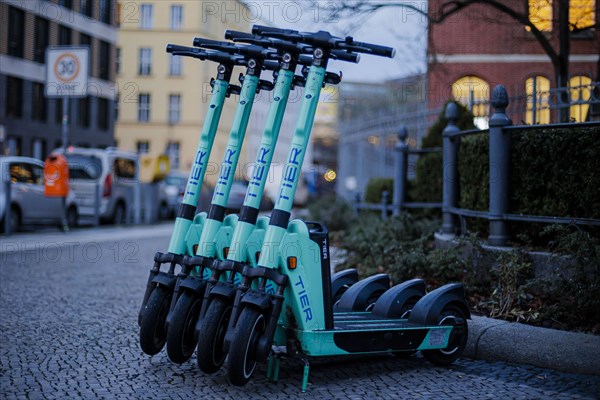 EScooters of the eScooter and bike rental company TIER stand on a pavement in Berlin Mitte. Berlin