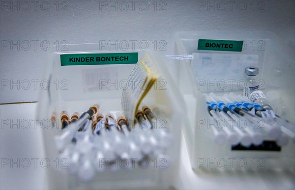 Drawn-up syringes with the BioNTech Pfizer vaccine for children lie ready for use in a COVID-19 vaccination and testing centre at the Olsen car dealership in Iserlohn