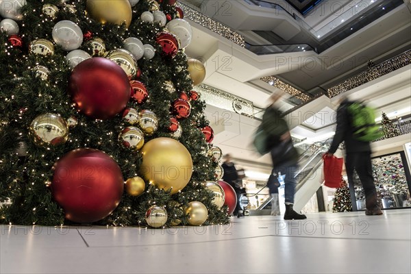 People stand out against Christmas decorations in a shopping centre on Schlossstrasse in Berlin