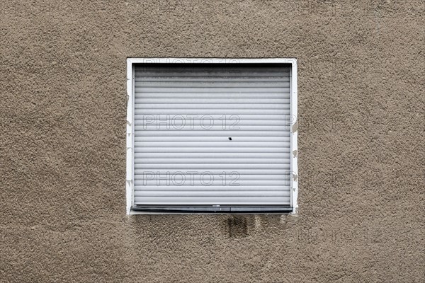 Lowered blinds stand out at an abandoned residential building in Berlin