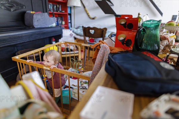 Toddler standing in a playpen