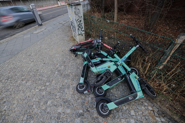 EScooters of the eScooter and bike rental company TIER lie on a pavement in Berlin Mitte. Berlin