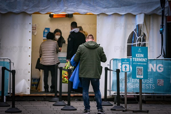 A man waits outside a Medicare COVID-19 testing centre for his testing appointment in Duesseldorf