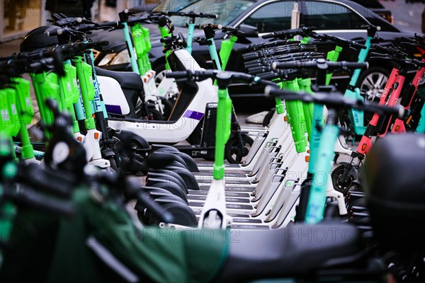 E-scooters of various providers standing on a designated parking space for sharing providers in Duesseldorf