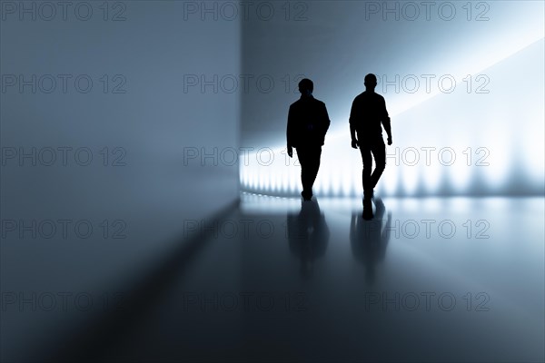 The silhouettes of two people stand out in the passageway between the Reichstag building and the Paul Loebe House in Berlin