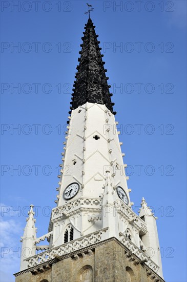 Black and white spire of the church of Saint Etienne serves as beacon for ships in Ars-en-Re on the island Ile de Re