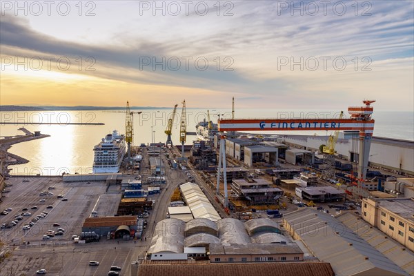 The Fincantieri shipyard in the industrial harbour at dusk