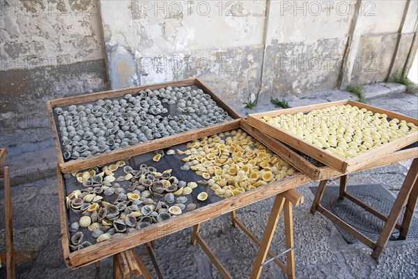 Orechiette pasta drying on wooden trays