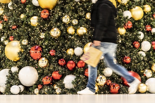 People stand out against Christmas decorations in a shopping centre on Schlossstrasse in Berlin