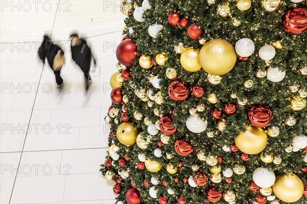 People stand out against Christmas decorations in a shopping centre on Schlossstrasse in Berlin