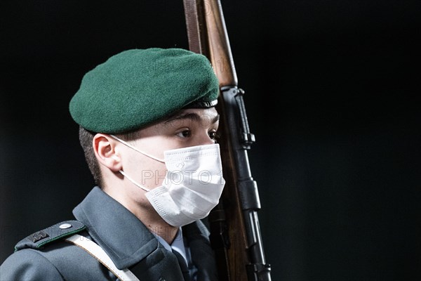 A soldier of the German Armed Forces wearing mouth-nose protection