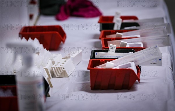 Rapid tests with stopwatches are ready in trays for use in a COVID-19 vaccination and testing centre at Autohaus Olsen in Iserlohn