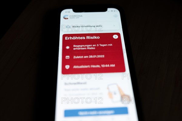 A red Corona Warn app indicates an increased risk of infection with Covid-19 coronavirus on an iPhone 12 Mini in Berlin