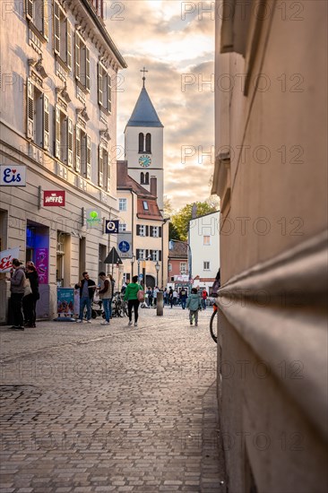 Lively cobblestone alleyway alley in the light of the evening sun