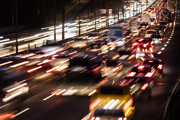 Congested traffic on the A100 looms at blue hour in Berlin