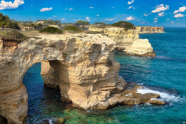 Rock stacks and crystal clear sea of the Faraglioni di Sant Andrea