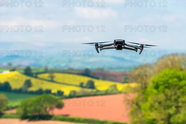 Drone in flight over fields and farms