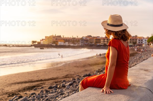 Tourist woman at sunset on vacation on the beach of Valle Gran Rey village on La Gomera