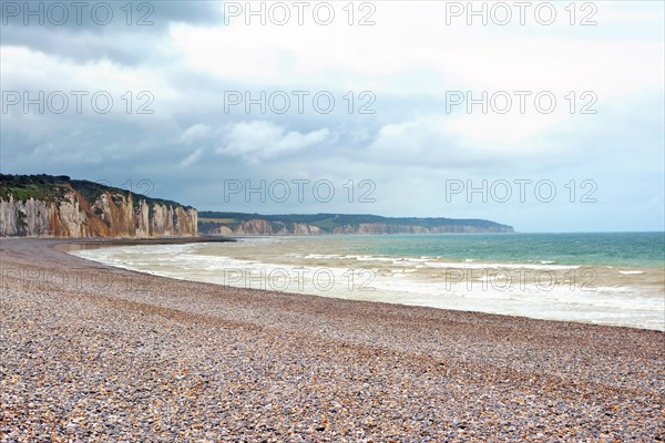 Scenery landscape view of pebble beach and cliffs in background in Dieppe in Seine Maritime department in the Normandy region of northern France