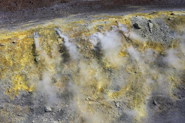 Smoking sulphur fumaroles at the crater rim