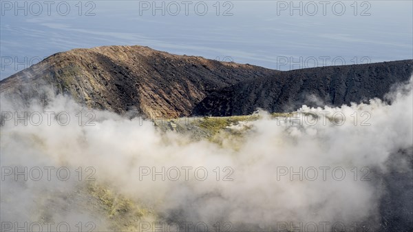 Smoking sulphur fumaroles at the crater rim