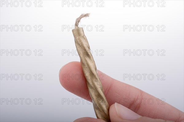 Gold colorl candle stick in hand on a white background