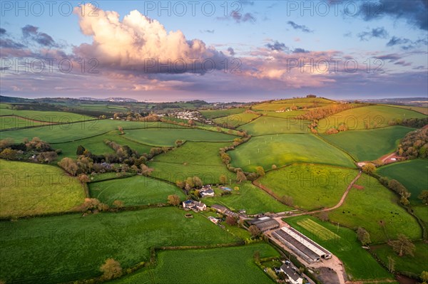 Sunset over fields and farms from a drone